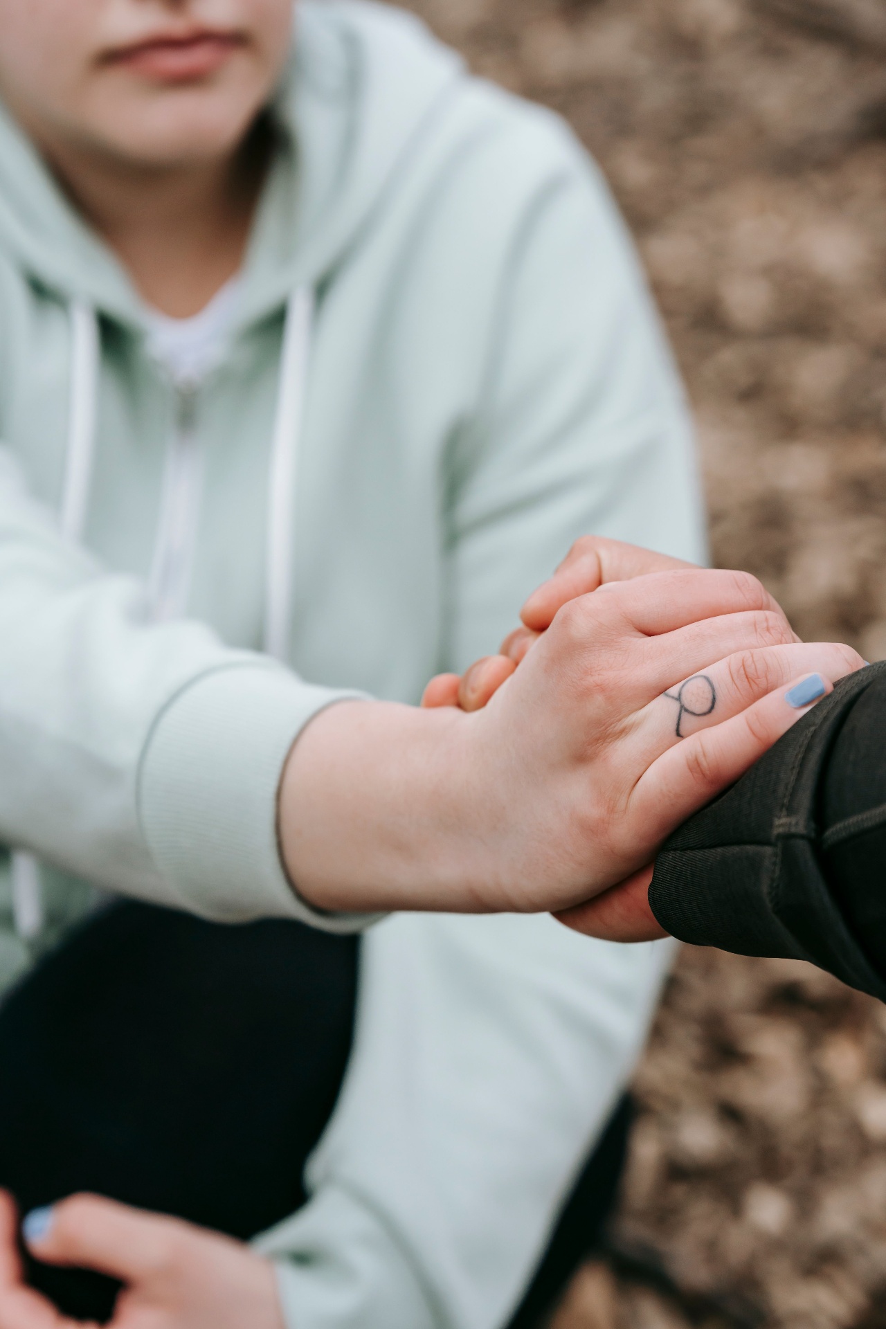 Practitioner offering a supportive, reassuring hand