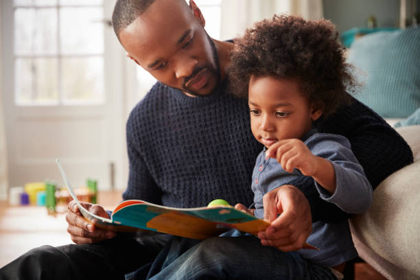 Father reading a picture book with his young child